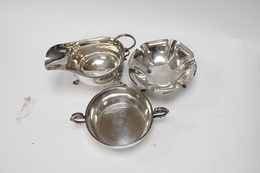 A silver quaich, E J Gallichan & Co Ltd, Sheffield, 1962, diameter 10.2cm, together with a silver sauceboat and a small silver dish, 10.1oz. Condition - fair